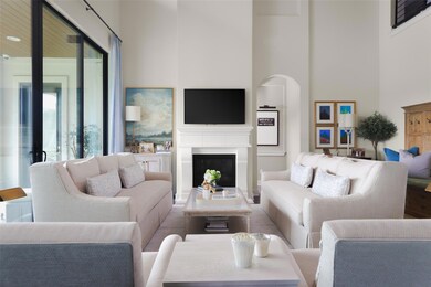 Living room featuring a towering ceiling and a fi