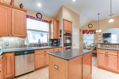 The kitchen hosts granite counters, double ovens and plenty of counter space.