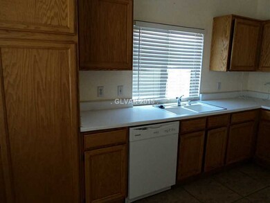 Property Photo. Kitchen kink with window. cabinetr