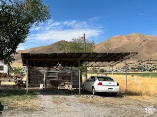 View of car parking featuring a mountain view and a detached carport