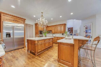 The well equipped kitchen is illuminated with a beautiful chandelier hovering over the new marble countertops and plumbing fixtures.The kitchen includes a huge Thermador gas cooktop,built in refrigerator,double ovens,advantium microwave,warming drawe
