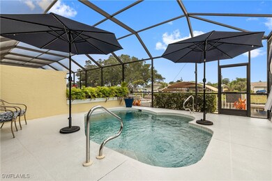 Pool featuring screen enclosure and a patio