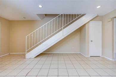 Unfurnished living room featuring stairs, recesse
