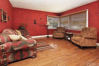 Living room with beautiful wood floors and windows