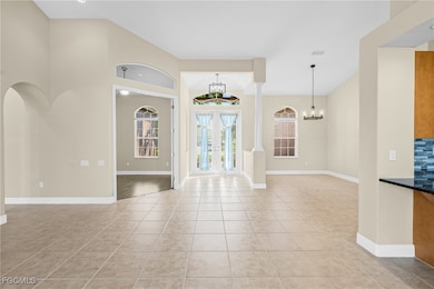 Foyer entrance featuring light tile patterned flooring and a chandelier
