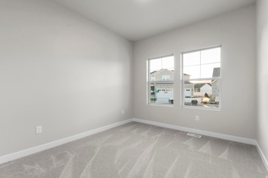 Unfurnished room with light colored carpet and baseboards