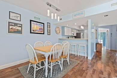 Dining space featuring baseboards and wood finished floors