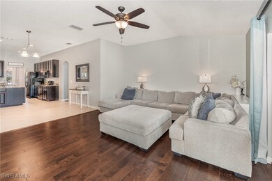 Living area featuring vaulted ceiling, arched walk