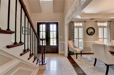 Two story foyer with gleaming marble floor.