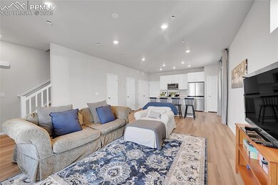Living room with light hardwood / wood-style floor