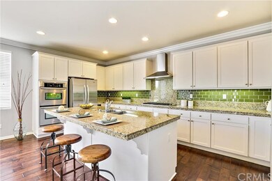 Gourmet kitchen with granite countertops, glass mosaic, double oven and stainless steel appliances