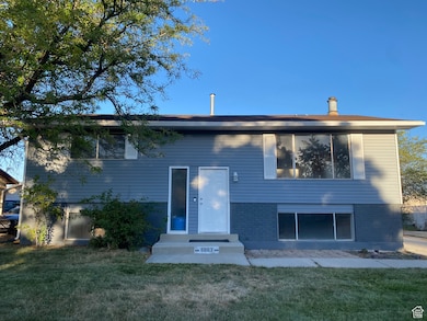 FRONT view of house featuring brick siding and a yard