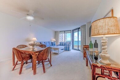 Carpeted dining area with ceiling fan and a wall o