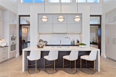 Kitchen featuring plenty of natural light, backsplash, a breakfast bar area, and a high ceiling