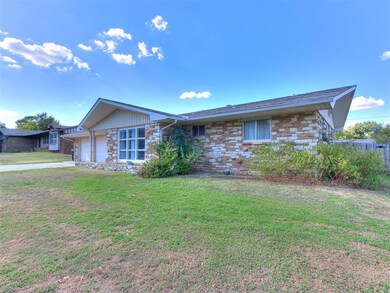 Ranch-style home with a front yard and a garage