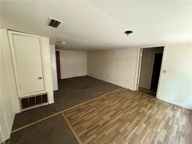Empty room featuring wood finished floors and baseboards