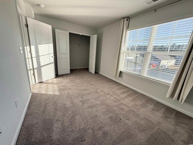 Unfurnished bedroom featuring light colored carpet