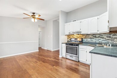 Glass tile backsplash, stainless gas stove
