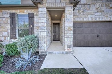 Property entrance featuring stone siding