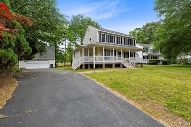View of front of house featuring a porch, an outbu