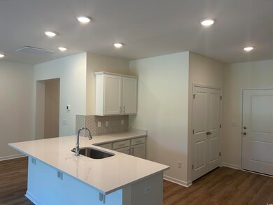 Kitchen with dark hardwood / wood-style flooring, 