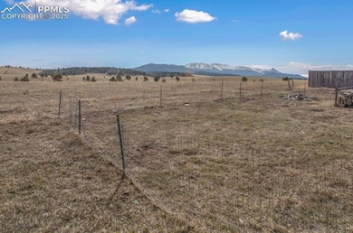 View of yard with a rural view, a mountain view, a
