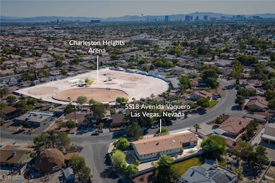 Aerial view of the back of the home and the horse