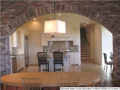 BRICK ARCHWAY LOOKING INTO KITCHEN FROM LIVING