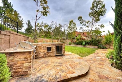 Custom built-in BBQ island accented with stone, gr