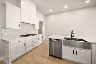 The quartz counters and large kitchen island provi