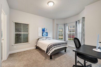 First-level bedroom with bay windows and an en-sui