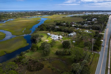 Aerial view of property's location with a large body of water