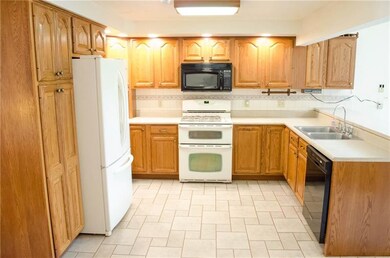 Kitchen with solid cabinets, recessed lighting, an