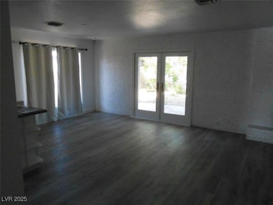 Empty room featuring french doors and wood finishe