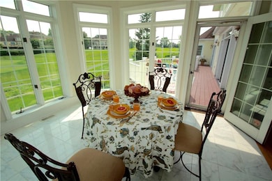 Eat-in-kitchen with walls of windows and access to