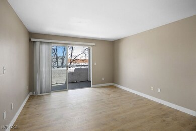 Spare room featuring baseboards and light wood-sty