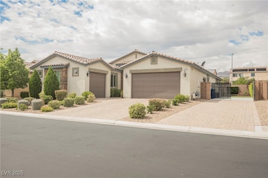 Mediterranean / spanish house with stucco siding, decorative driveway, a gate, and a tiled roof