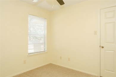 Empty room featuring light colored carpet, a ceili