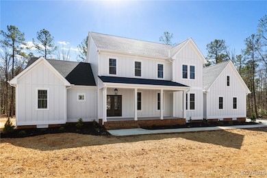 Modern farmhouse style home featuring covered porch, roof with shingles, crawl space, and board and batten siding