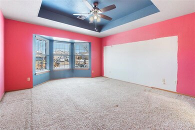 Unfurnished room with carpet floors, a raised ceil