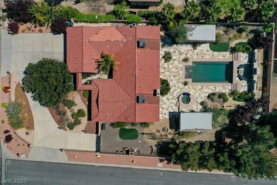 Aerial view of corner lot property with circular d
