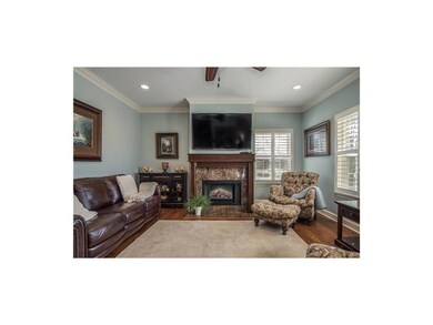 The fireplace ha a stunning cherry and marble surr