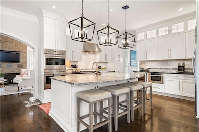 Kitchen with an inviting chandelier, white cabinet