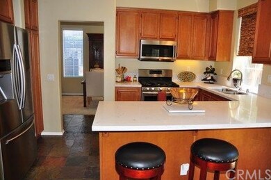 Quartz Counters and Slate Flooring with Stainless 