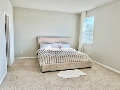 Carpeted bedroom featuring baseboards