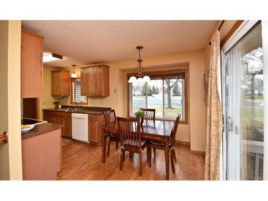Dining area has wood floors and a sliding glass do