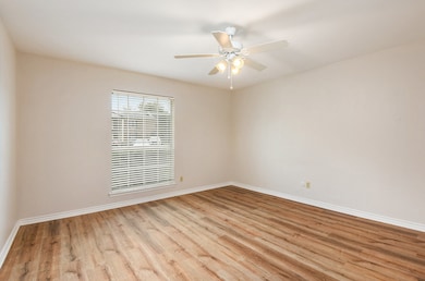 Unfurnished room featuring light wood-style flooring and a ceiling fan