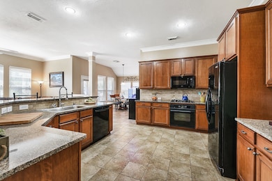 Gourmet kitchen!  Large breakfast bar, granite counter tops, NEW farmhouse sink, 42 inch wood cabinets with hardware, stone backsplash, and walk in pantry with custom spice rack.