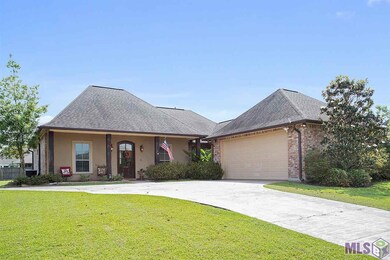 Landscapped yard & inviting porch will welcome you