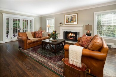 Large living room has French doors that open to th